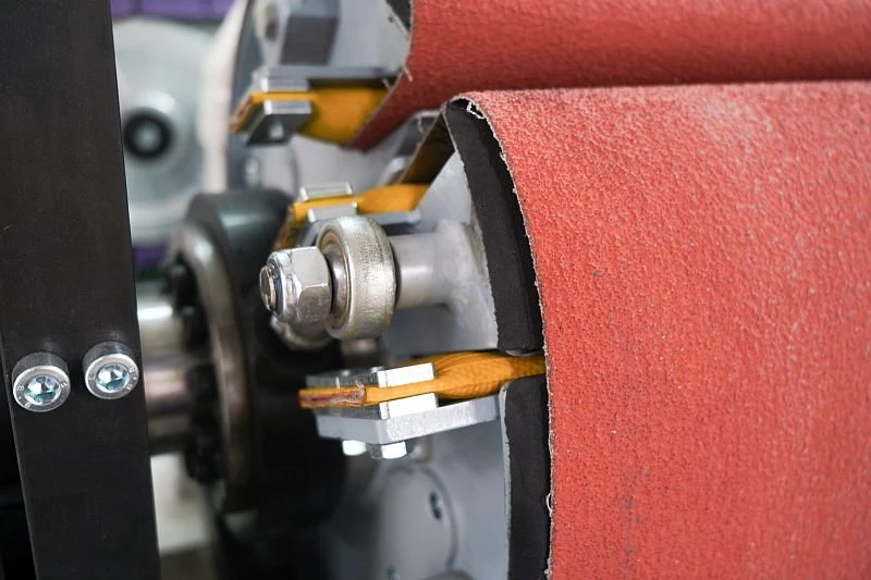 NS DM1100 DC EVO - Odjehlovací stroj - jednotka s brusným válcem - detail upínání brusného plátna na válec